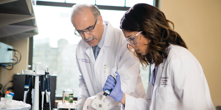 Researchers work in lab. 